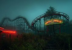 an amusement park at night with the neon sign for fatal emelee on it