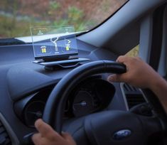 a car dashboard with an electronic device in the center and text that reads meet explore