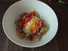 a white bowl filled with food on top of a table