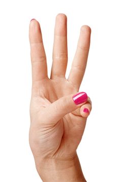 a woman's hand with pink and white nail polish holding up the peace sign