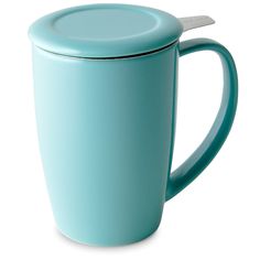 a teal colored mug with a spoon in the cup and lid is shown on a white background