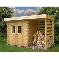 a wooden shed with logs stacked in it