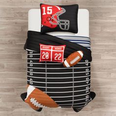 a football themed comforter set on a bed