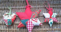 four red and green christmas ornaments on a wicker table