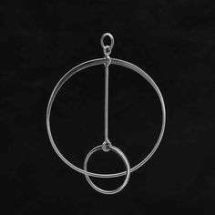 a metal object hanging from the side of a black wall with two circles in it