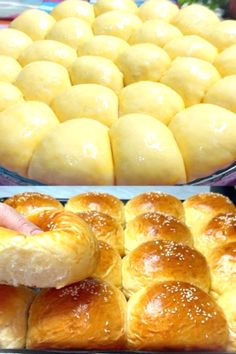 there are many different types of breads in the display case, and one is being held by someone's hand