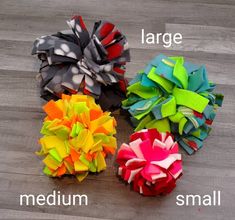 three different types of hair bows sitting on top of a wooden floor