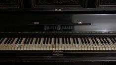 an old black piano with the words south and greener on it's side