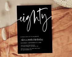 a black and white birthday party card with the word eighty written in cursive font