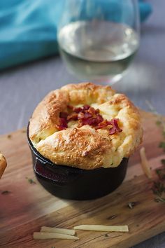 there is a pot pie with bacon in it on the table next to some bread