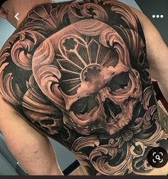 a man with a skull tattoo on his back