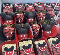 chocolate covered strawberries in the shape of mickey mouses with faces and noses on them