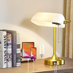 a desk lamp sitting on top of a wooden table next to a bookshelf