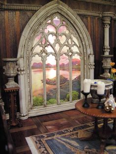 a living room filled with furniture and a stained glass window in the middle of it