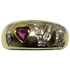 14k yellow gold "Love" ring with 1 heart shape cut ruby weighing .40ts. and 28 round full cut diamonds weighing .25pts. spelling out "love". This ring is a size 6.5 but we will size to fit for free. Gold Love Ring, Ring With Ruby, Ruby Jewellery, Ruby Heart, Diamond Heart Ring, Ring Heart, American Modern, Jewelry Tags, Ruby Jewelry