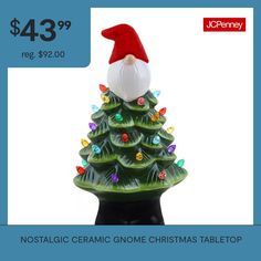 a ceramic christmas tree with santa's hat on top is for $ 43 99