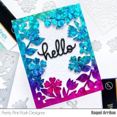 a card with the word hello written in black ink on it and some paper flowers