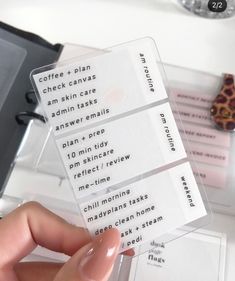 a person holding up some business cards on a desk