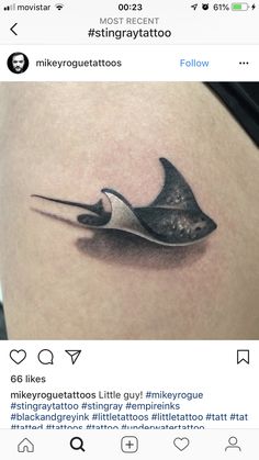 a tattoo on the side of a woman's thigh with scissors stuck in it