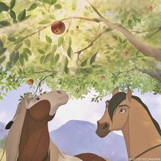 two horses standing next to each other under a tree with an apple on it's branch