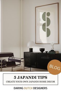 a living room with white walls and black furniture in front of a large framed art piece