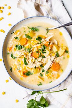 a white bowl filled with chicken and corn soup