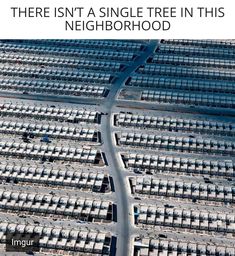 an aerial view of a parking lot with many cars parked in rows on the sides