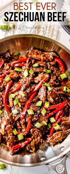 the best ever korean beef is served in a silver bowl with red peppers and green onions