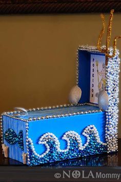 a blue box decorated with pearls and beads