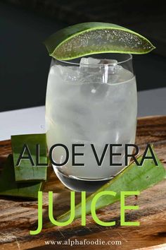 an aloe vera juice in a glass with a slice of lime on the rim