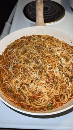 a pan filled with spaghetti sitting on top of a stove