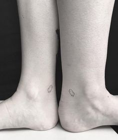 two people with small tattoos on their legs, one has a bird and the other has a heart