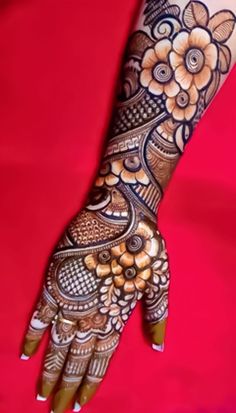 the hand is decorated with henna and flowers