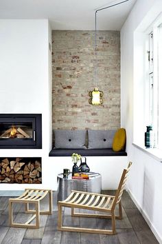 a living room filled with furniture and a fire place next to a wall mounted fireplace