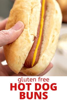 a person holding a hot dog bun in their hand with the text gluten free hot dog buns