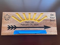 a wooden plaque with arrows and the words do your best