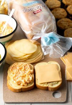 bread, cheese and other food items on a cutting board