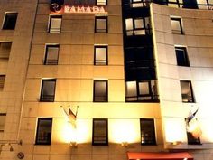 a tall building with windows lit up at night