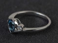 Welcome to my shop, you can find many beautiful gemstone jewelry here, and you also can ask for customized service. Main Stone: London blue topaz, pear cut, measures 5*7mm, weight about 0.95 carats.Accent Stones: czMetal: 925 sterling silver plated with rhodium. I also can provide metal options such as 14k solid yellow/white/rose goldSetting: bezel settingmore rings: https://www.etsy.com/shop/XCjewelryStudio?ref=hdr_shop_menuIt's a perfect gift for the person who was born in November (Birthstone Heart Cut Blue Topaz Gemstone Rings, Pear-shaped Topaz Jewelry For Anniversary, Blue Topaz Heart Cut Gemstone Rings, Fine Jewelry Blue Topaz Teardrop Rings, Elegant Trillion Cut Ring With Bezel Setting, Pear-shaped Blue Topaz Jewelry For Anniversary, Pear-shaped Topaz Promise Ring, Pear-shaped Topaz Jewelry With Accent Stones, Silver Trillion Cut Sapphire Ring With Accent Stones