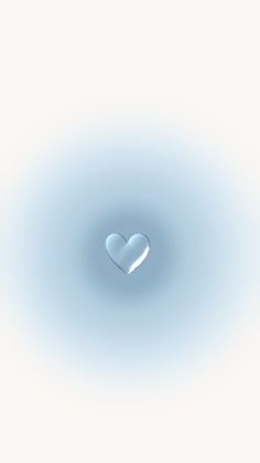 a heart shaped object in the middle of a light blue background with water droplets on it