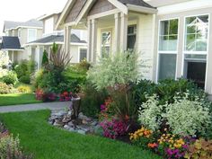 the front yard is full of flowers and plants