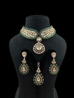 Green Polki Choker emerald Kundan centerpiece surrounded by radiant Kundan Polki stones, crafted in gold with intricate Jadau detailing. Inspired by Sabyasachi, it boasts the brilliance of Moissanite and uncut diamonds, offering a statement of opulent elegance perfect for a grand Indian wedding. *𝐏𝐑𝐎𝐃𝐔𝐂𝐓 𝐃𝐄𝐓𝐀𝐈𝐋* * Material: Brass * Plating: Gold Plated * Stone: Semi Precious Kundan, Polki & Green Stone. *𝐃𝐈𝐒𝐂𝐋𝐀𝐈𝐌𝐄𝐑* Product color may slightly vary due to photographic light Green Jewelry Sets With Intricate Design For Reception, Dazzling Gold Emerald Necklace, Wedding Kundan Necklace With Emerald Intricate Design, Dazzling Kundan Bridal Necklace For Festive Occasions, Festive Green Diamond Bridal Necklace, Festive Emerald Bridal Necklace With 17 Jewels, Green Jeweled Jewelry For Reception, Green Kundan Bridal Necklace Hand Set, Festive Kundan Emerald Necklace For Receptions