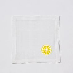 a white napkin with a yellow lemon on it