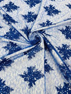 blue and white fabric with floral design on the bottom, as well as an intricate pattern