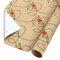 a roll of wrapping paper on top of a white surface with an image of gnomes and christmas lights