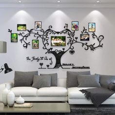 a living room filled with white furniture and pictures on the wall above it's tree