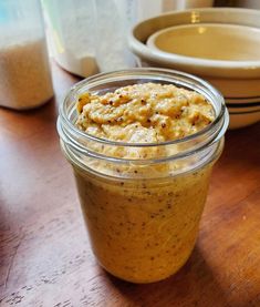 a jar filled with food sitting on top of a wooden table