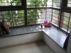 a window sill with two vases sitting on top of it