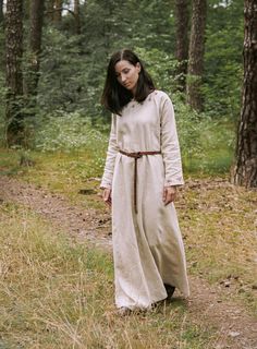 "This early medieval linen dress is universal for the Vikings and Slavs or any other reenactors. Based on medieval iconography and archaeological finds from Europe. Imagine how you walk around the field, and then go to the forest to collect wild apples to return home with sweets, where your family is waiting for you. And you can do all this in our dress. Soaked in the history of Slavs and Scandinavians, the dress is perfect for any time of the year. And, of course, perfect for you. The dress has