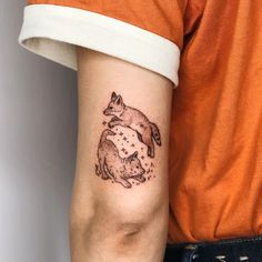 a person with a small tattoo on their arm holding onto the arm of another animal